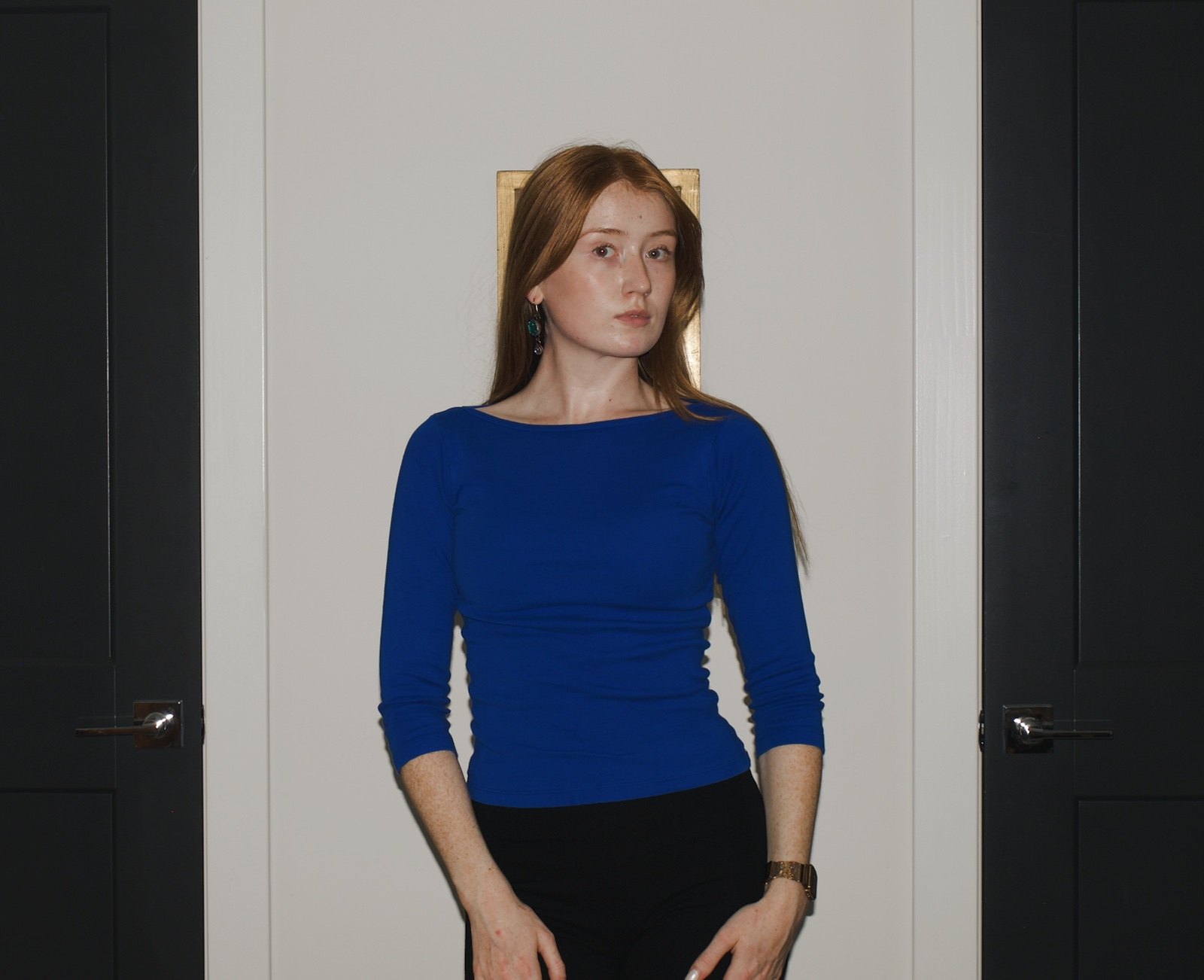 Close-up of Emma wearing a royal-blue Los Angeles Apparel Baby Rib boatneck top