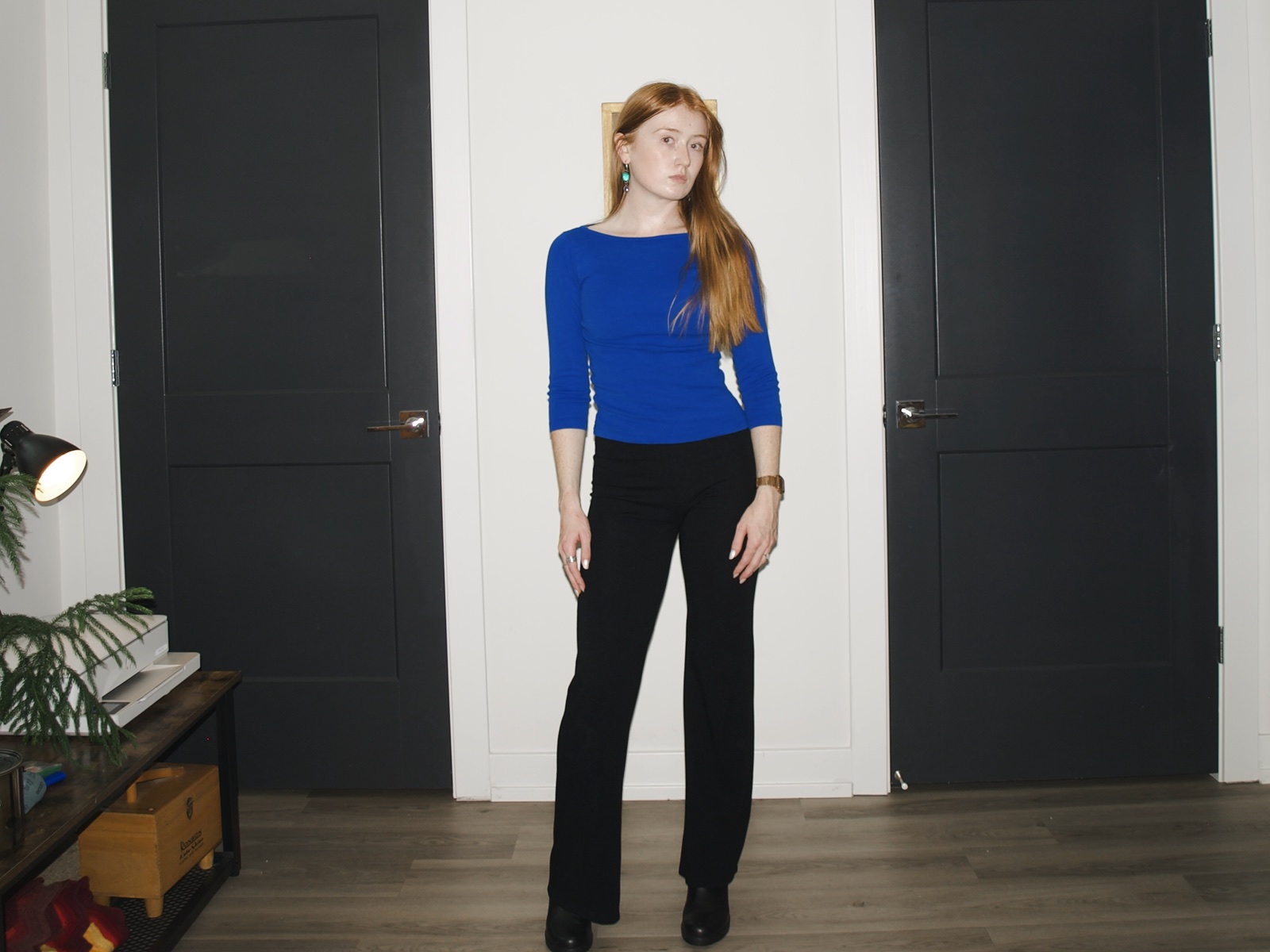 Emma wearing black Los Angeles Apparel Ponte flare leggings with a royal-blue boatneck top