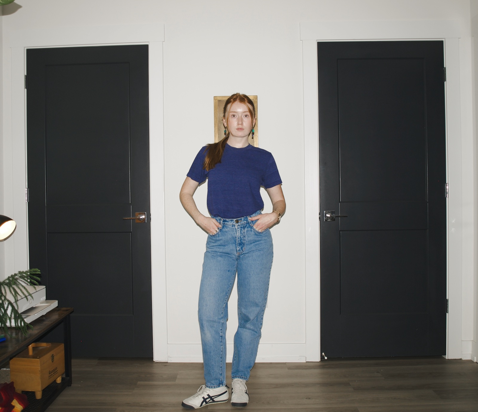 Emma wearing a blue tri-blend T-shirt tucked into light-wash Los Angeles Apparel relaxed-fit jeans
